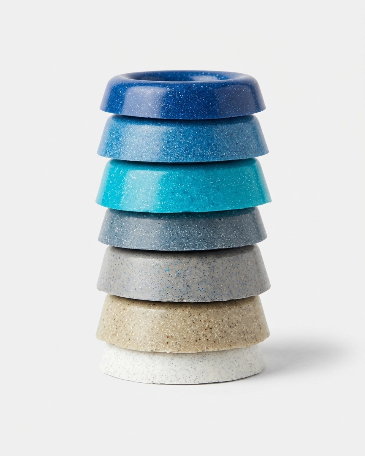 Stacked fibreglass pool colour samples in blues, greys and neutrals